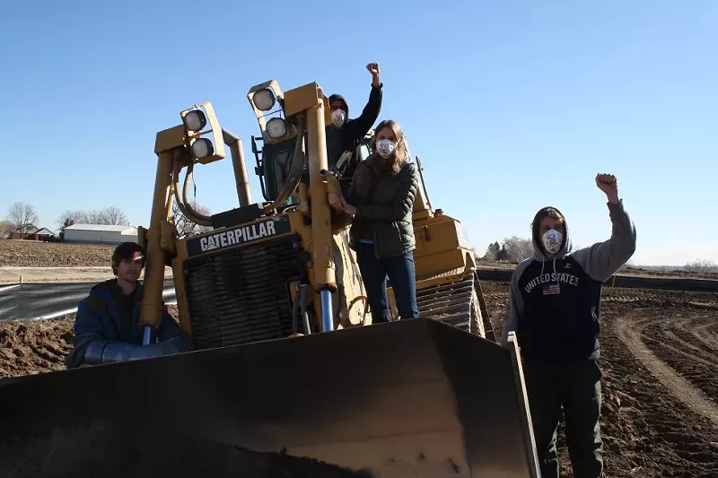 Image: Cullen Lobe, left, locked himself to a bulldozer during an anti-fracking protest on March 8 at a drilling site near Bella Romero Academy in Greeley.
