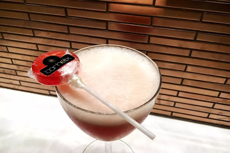 Image: Bar Helix invites you to suck a Negroni. The Suck My Negroni cocktail is made with egg whites and comes with a housemade Negroni lollipop.