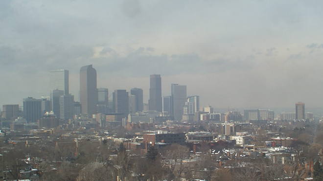 The Denver skyline blurred out by gray and brown smog.