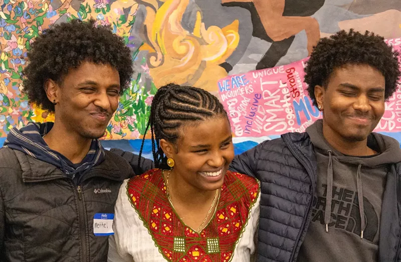 Image: Rodas Tewelde with her older brothers Metkel (left) and Asmerom (right) at her February fundraiser event for Eritrean refugee families.
