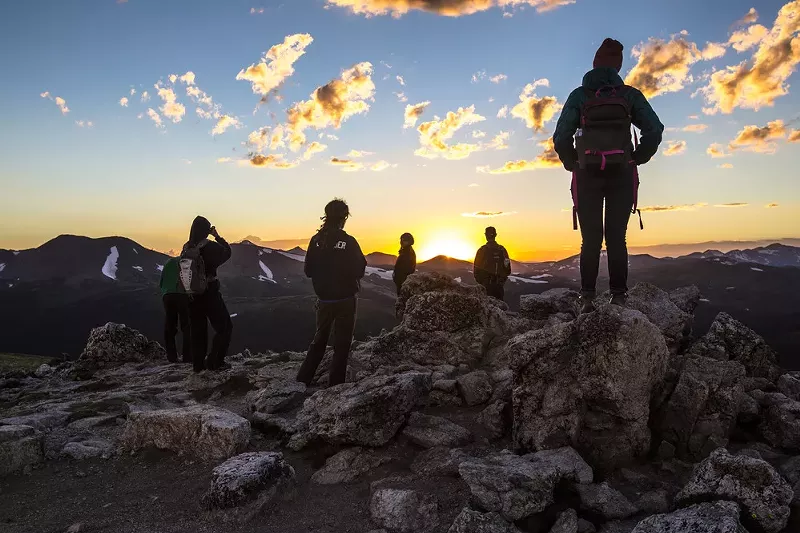 Image: Hikers stare into sunset