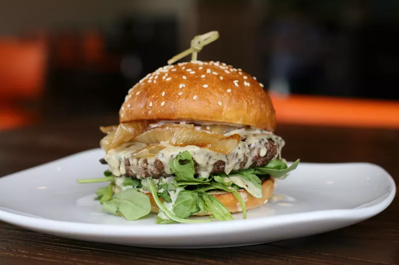 Image: A burger dripping with Gruyère fondue at the new Westminster 5280 Burger Bar.