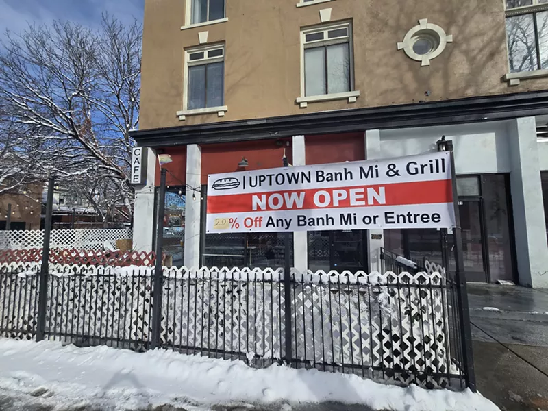 Image: "now open" sign on a fance