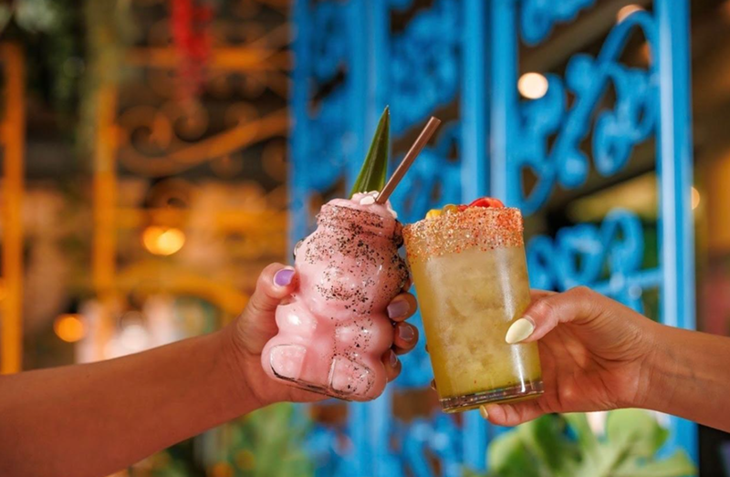 Image: hands holding a frozen drink anda margarita