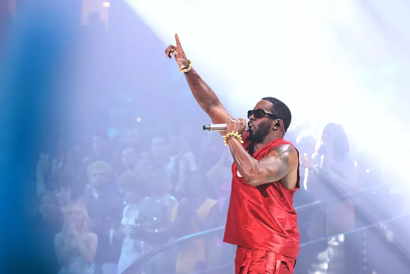 Image: P Diddy performing in a red jersey