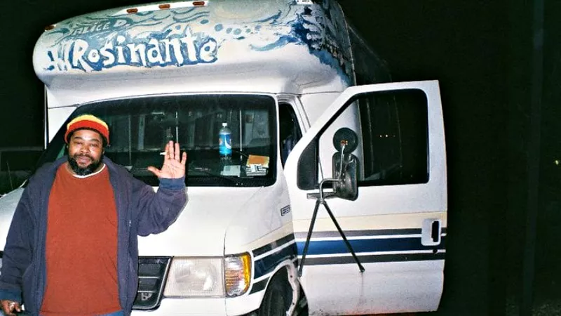 Image: Keith Hammock posing with the Rasta Bus he once drove.