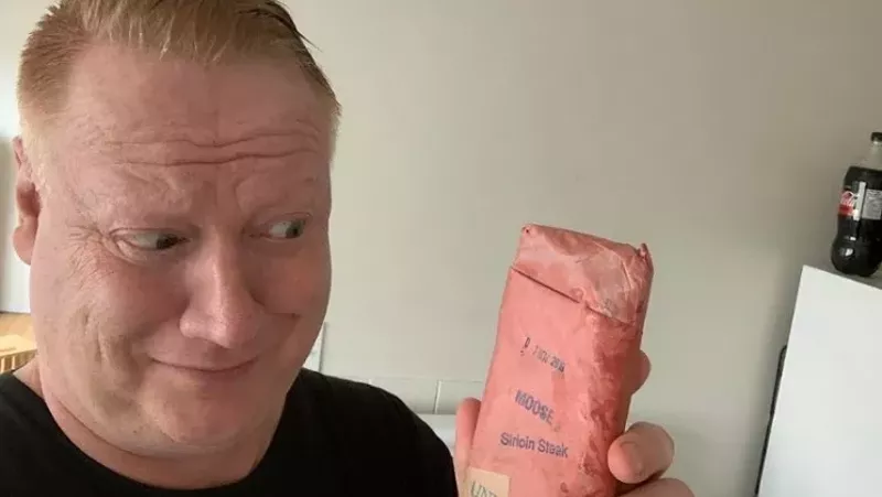 Image: Adrian Dater eyeballing a slab of moose meat he found in the freezer of his Edmonton Airbnb in July 2020.