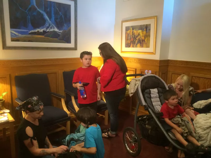 Image: Michelle Walker and her son, Vincent Zuniga, stand in the waiting room outside Governor John Hickenlooper's office on June 5.