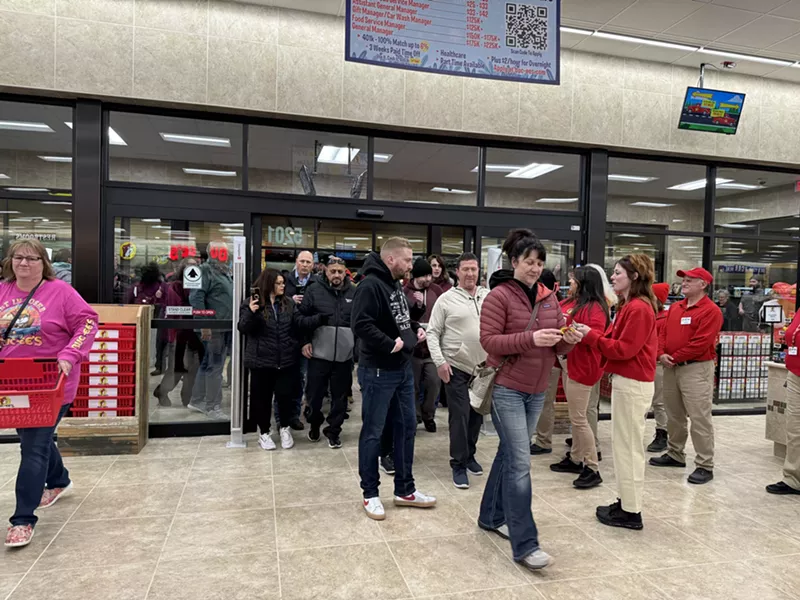 Image: a line of people walking into a store