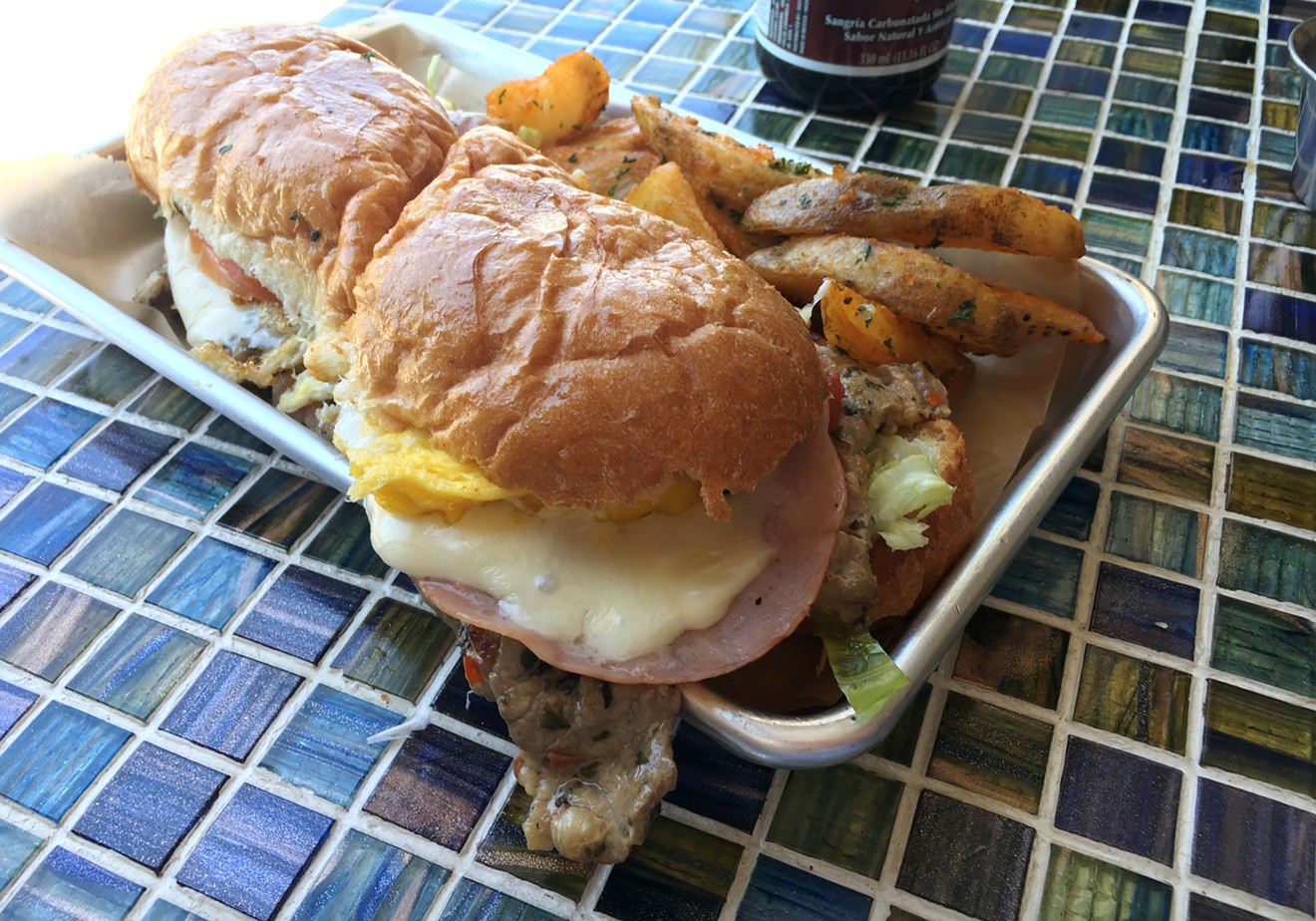 Carne's lomito sandwich is loadd with grilled pork, ham eggs and cheese.