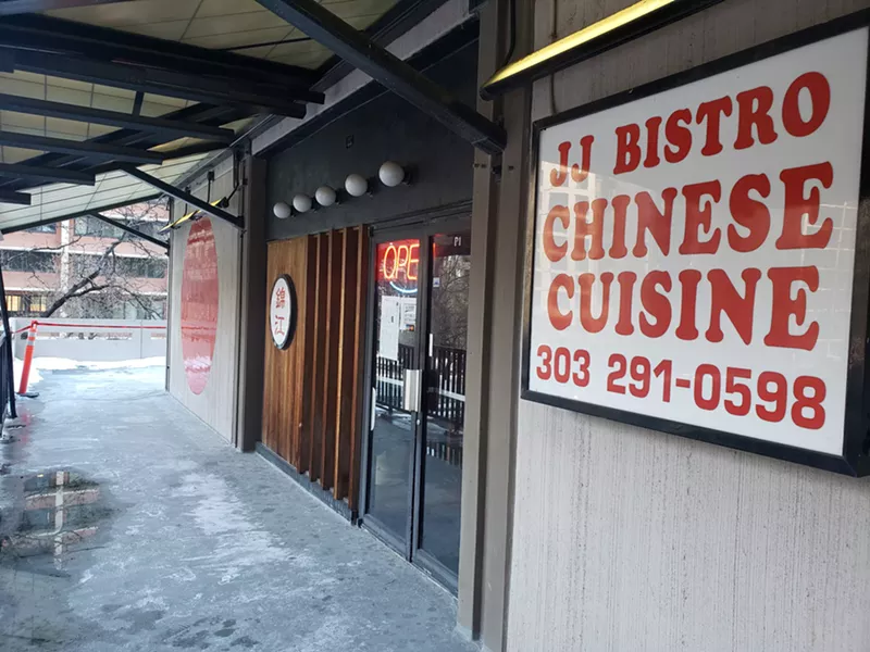 Image: a red and white sign outside a storefront