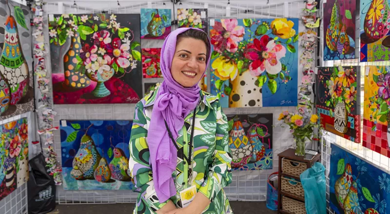 Image: Art Students League of Denver instructor Bahnez Ahmadian greets art lovers at the Summer Art Market.