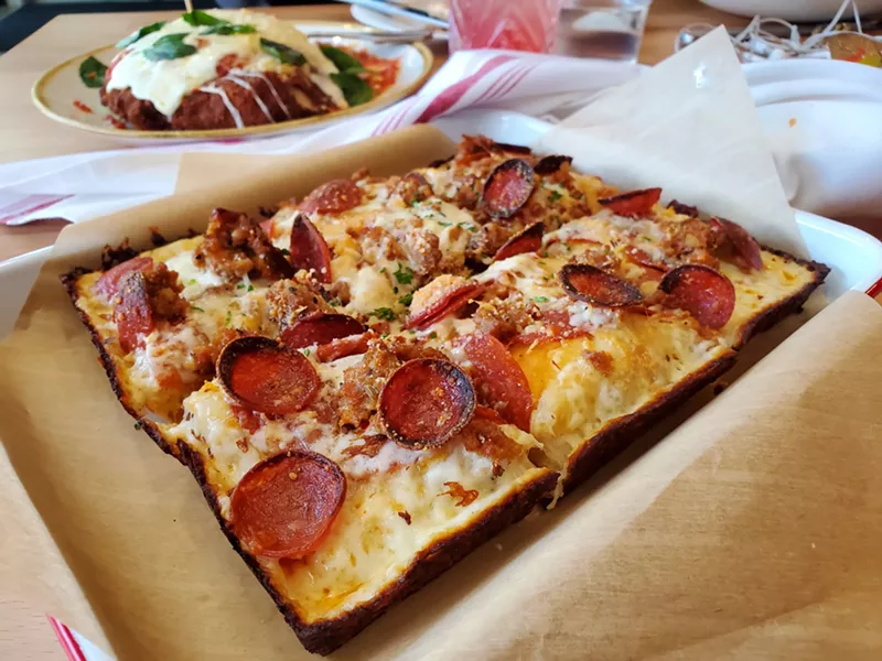 Image: a square cut rectangular pizza with pepperoni and sausage