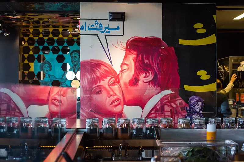 Image: Arabic movie posters from the 1950s and ’60s add drama to every vertical surface that's not a window.
