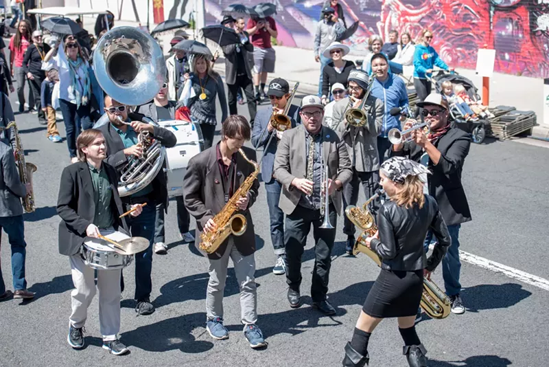 Image: a brass band plays in a parade