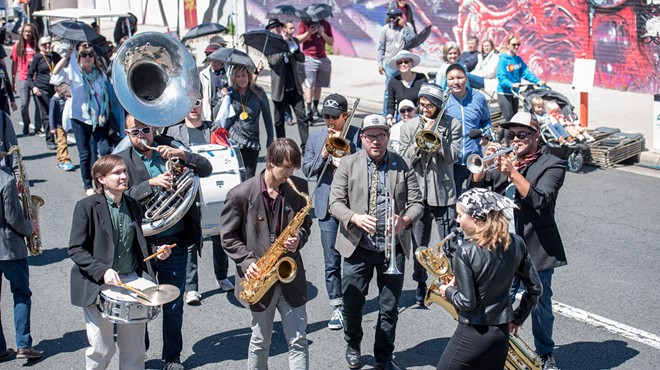 a brass band plays in a parade