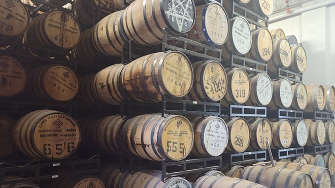 barrels on racks in a distillery