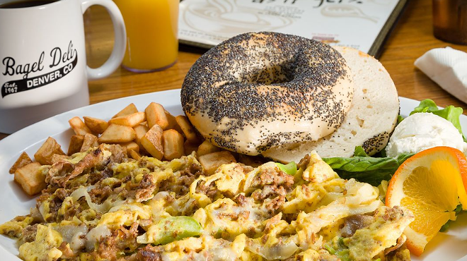 veggies mixed into eggs, fried potatoes and bagel