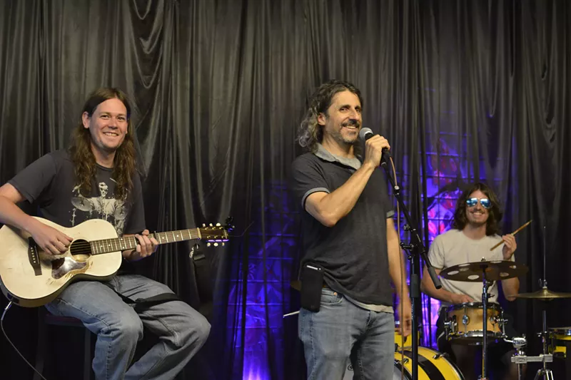 Image: Herman Gauche (center) has been an open-mic host at the Merc for nearly twenty years.