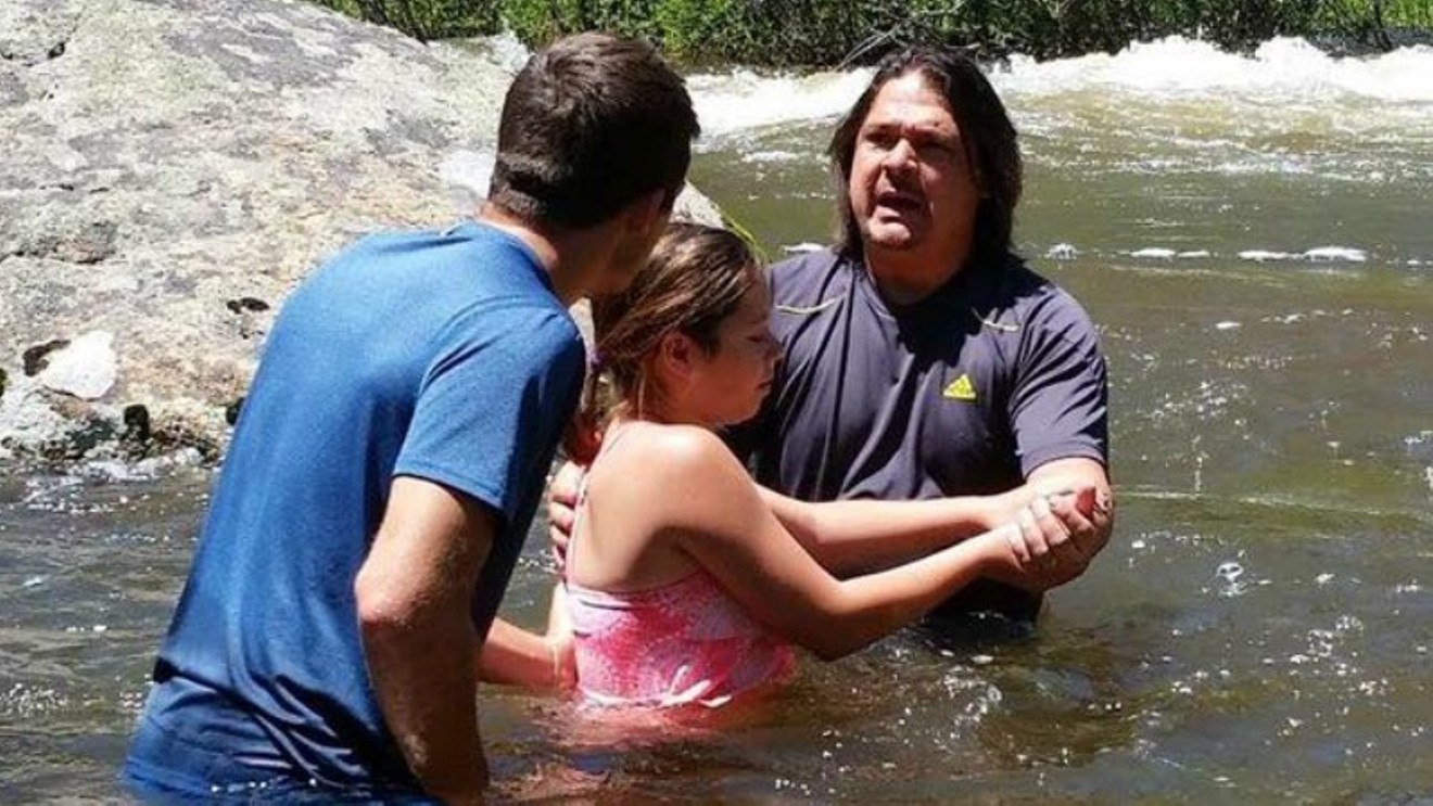 A Facebook photo of Paris Wallace conducting a baptism.