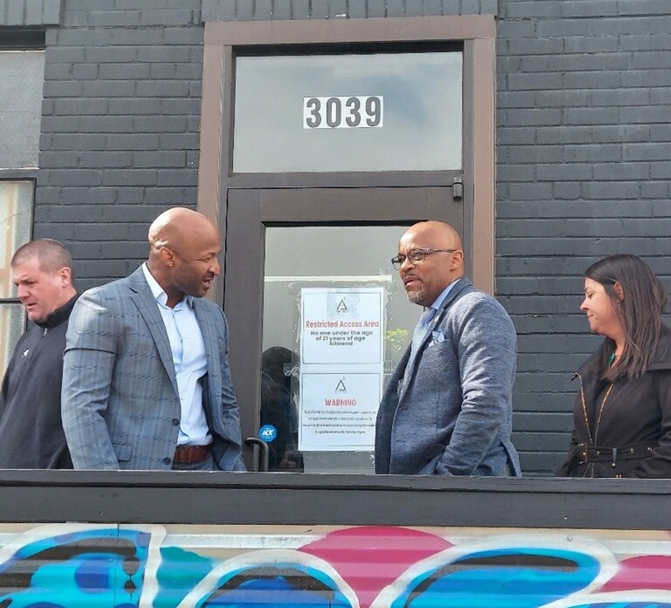 Tetra Lounge owner Dewayne Benjamin greets Mayor Michael Hancock and Denver Department of Excise and Licenses director Molly Duplechian during a ribbon-cutting ceremony March 30.