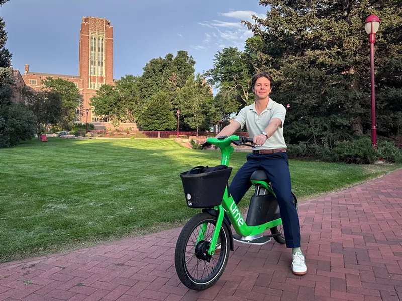Image: College student sits on e-bike