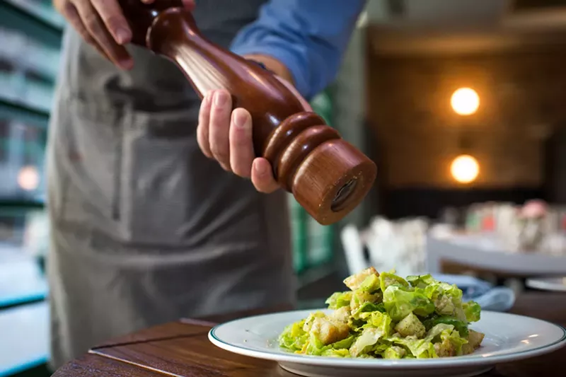 Image: The Caesar salad at French 75 is prepared tableside.