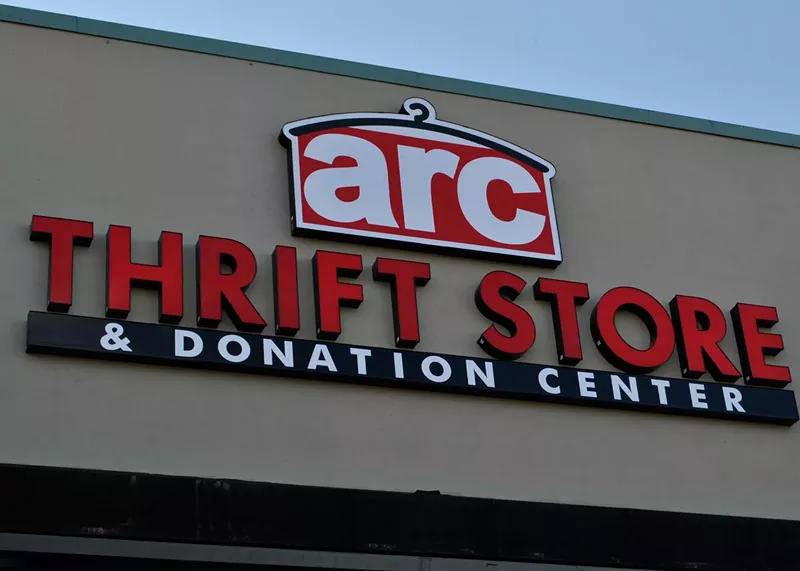 Image: a building with a sign that reads Arc thrift stores.