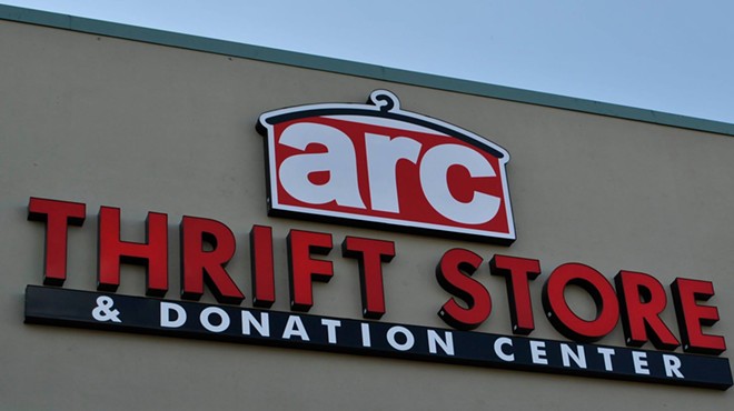 a building with a sign that reads Arc thrift stores.