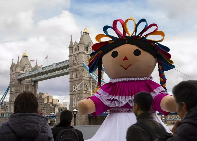 Image: The giant Lele doll at the Tower Bridge in London, England in 2019.