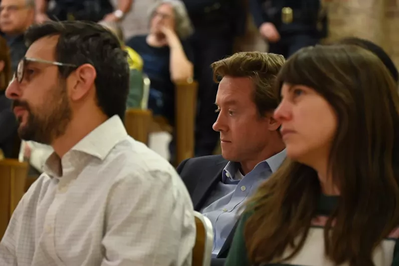 Image: Mayor Mike Johnston sits in the crowd.