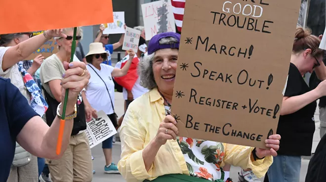 A protester holds up a sign.