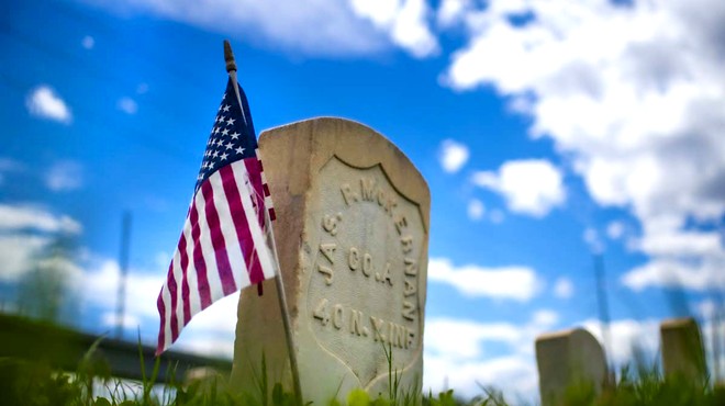 gravestone with flags.