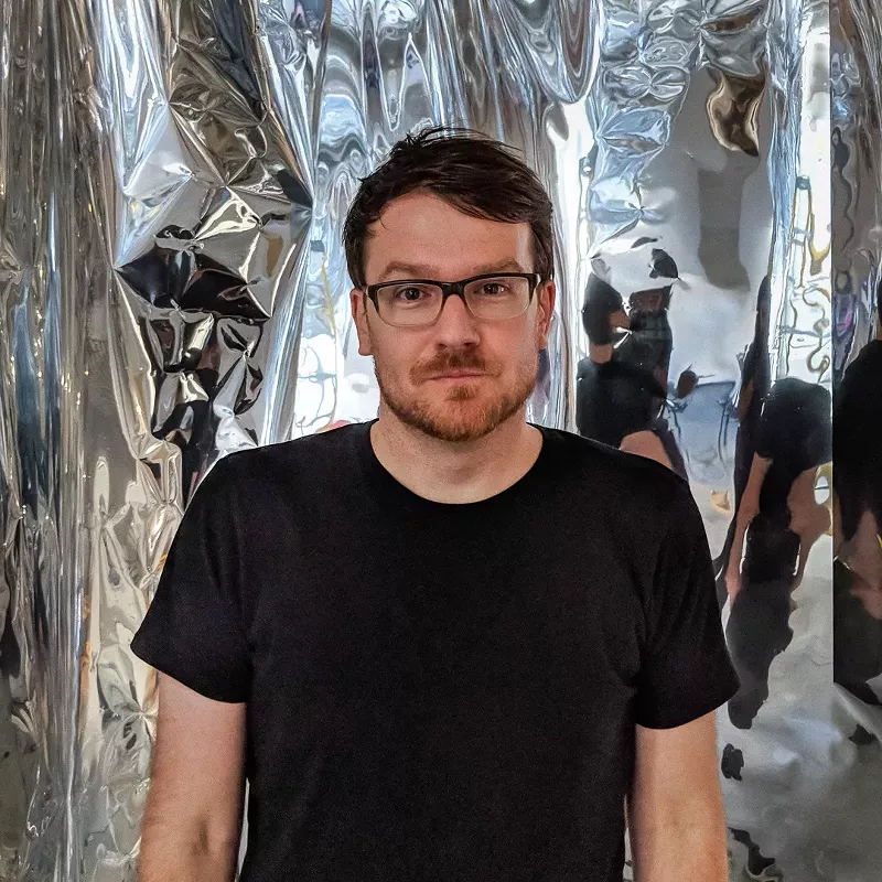 Image: Robert Seidel poses within his installation "Tarnish," at Understudy, in conjunction with Supernova.