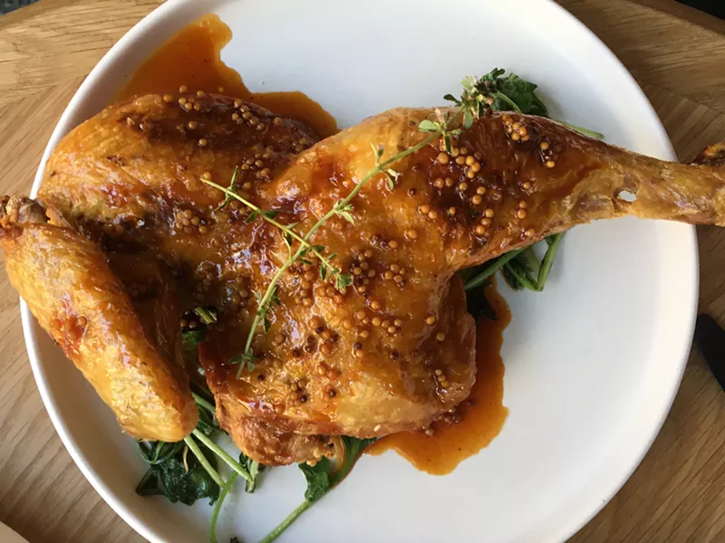 Image: A roasted half chicken with Rebel Farm greens is a good representation of the menu at Local Jones.