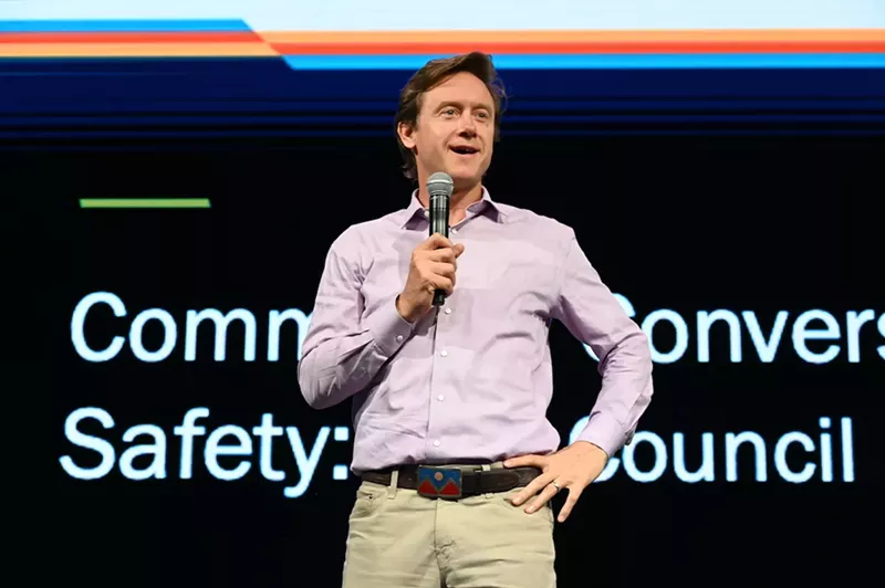 Image: A man stands on stage.
