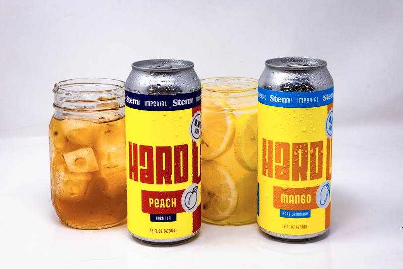 Image: two mason jar glasses next to two cans
