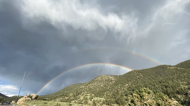 a double rainbow over mountains