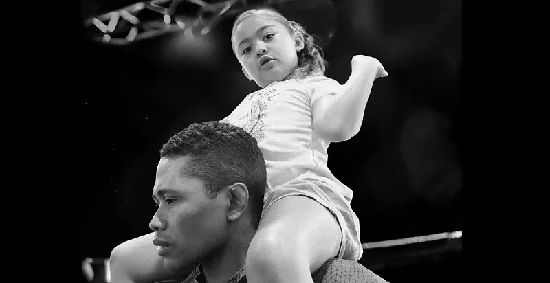Image: man with little girl on shoulders.