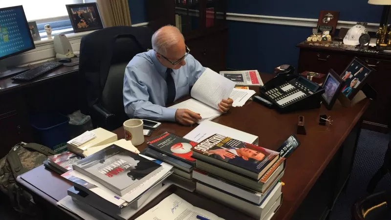 Image: From Mike Coffman's Facebook page: "Got back to DC and I'm closely reading #healthcare bill text to make sure it is in the best interest of #CO06 residents."
