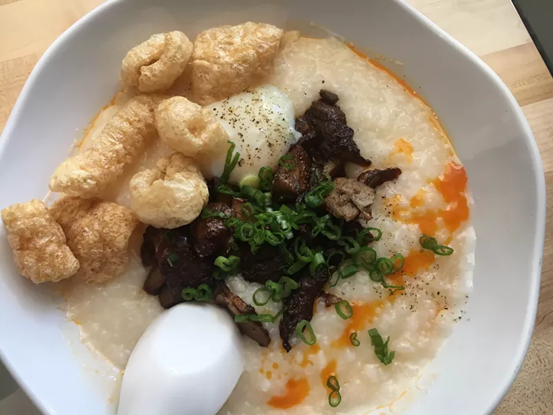 Image: Naked Bowl's pork congee is rice porridge with shredded pork, cracklings, chile oil and a poached egg.