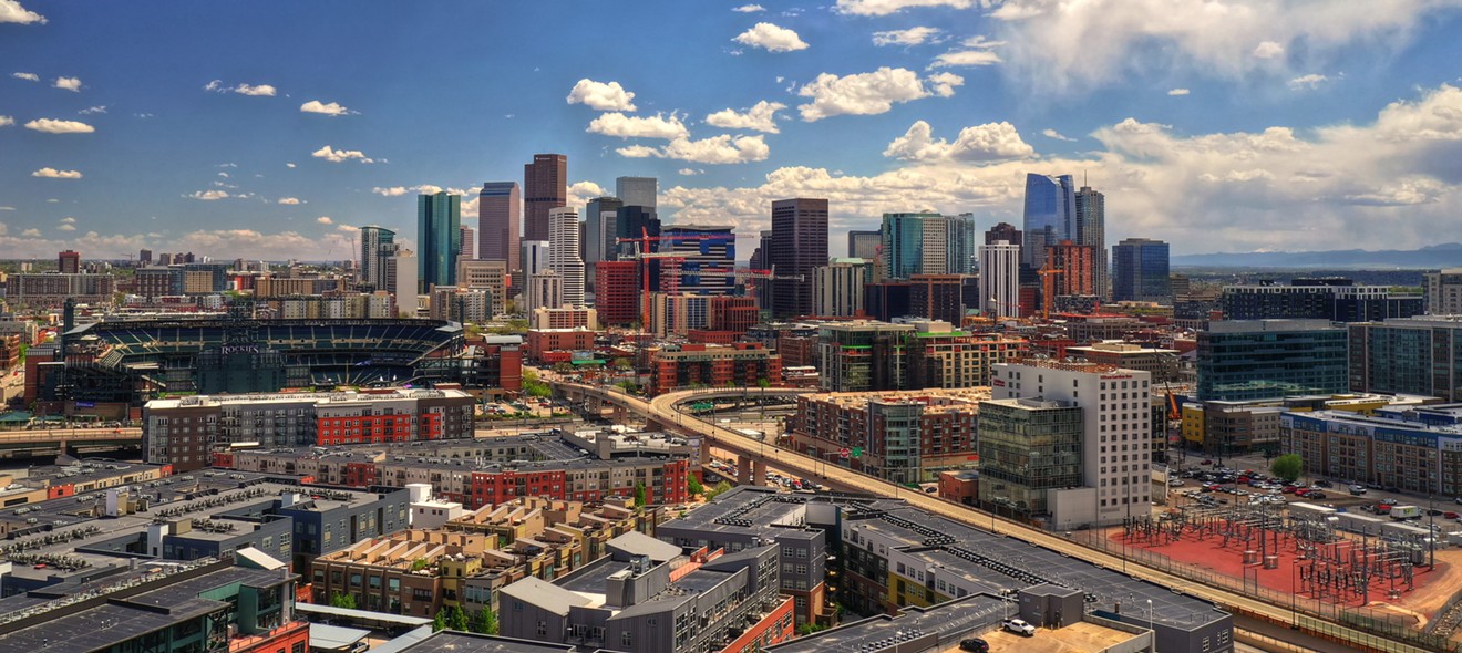 Denver's skyline under bright blue skies.