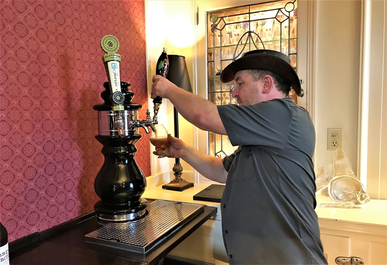 Tim Myers of Strange Craft Beer Company fills a glass at the mansion.