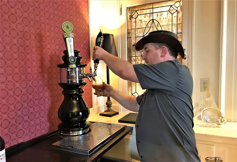 Image: Tim Myers of Strange Craft Beer Company fills a glass at the mansion.