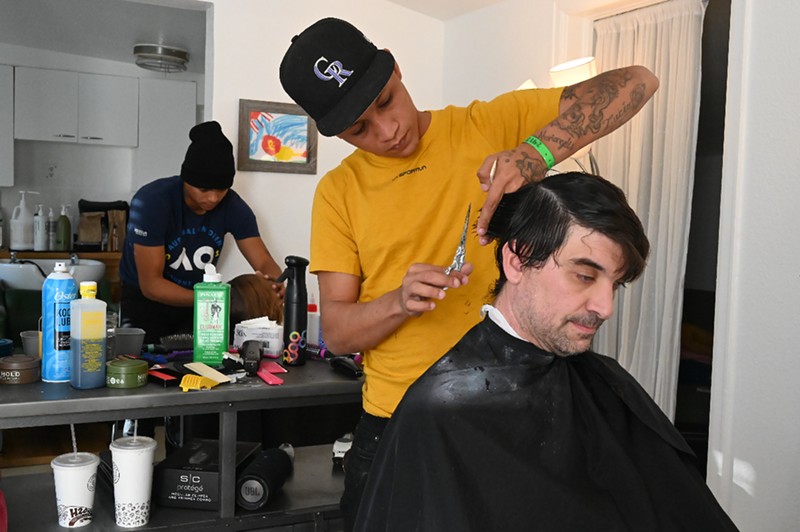 Manuel Salazar, front, and Carlos Majano cut hair as part of a pop-up barbershop set up on Sunday, November 12 by a member of the Highland Mommies.