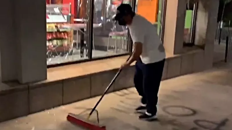 Image: Cleanup outside a vandalized downtown Quiznos located in a building owned by the Colorado Coalition for the Homeless.