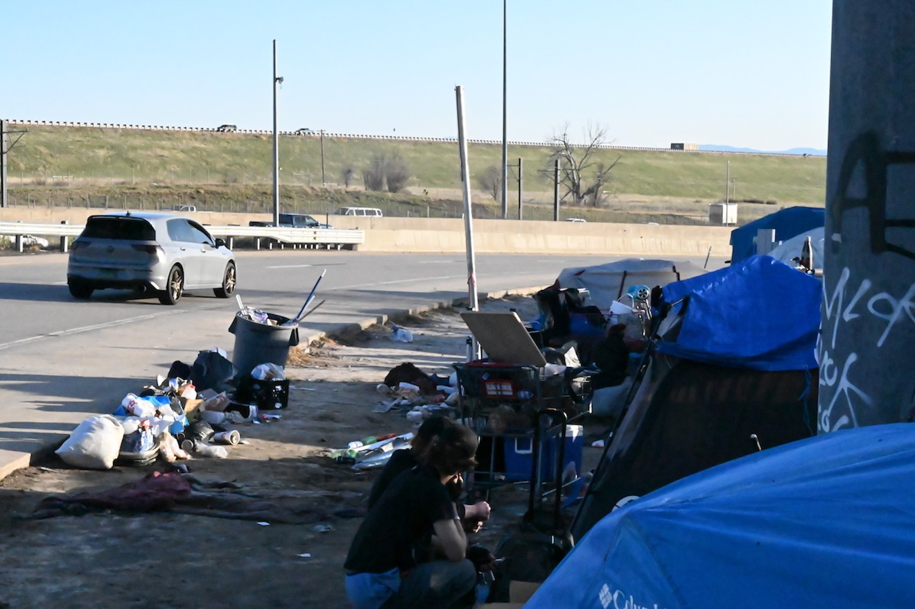 A homelessness encampment sits along the Interstate 225 on ramp from Parker Road in Aurora.