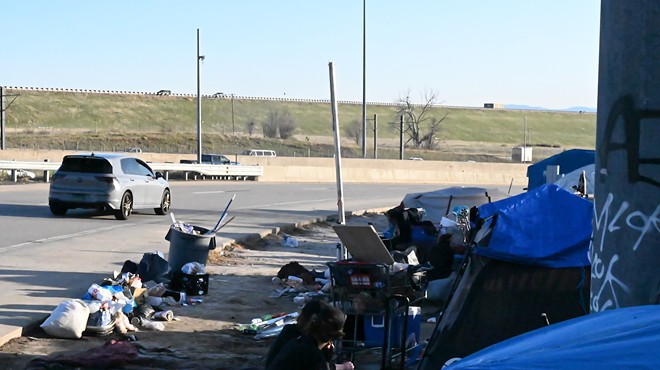 A homeless encampment sits next to Interstate 225 and Parker Road, a popular route through Aurora to Denver.