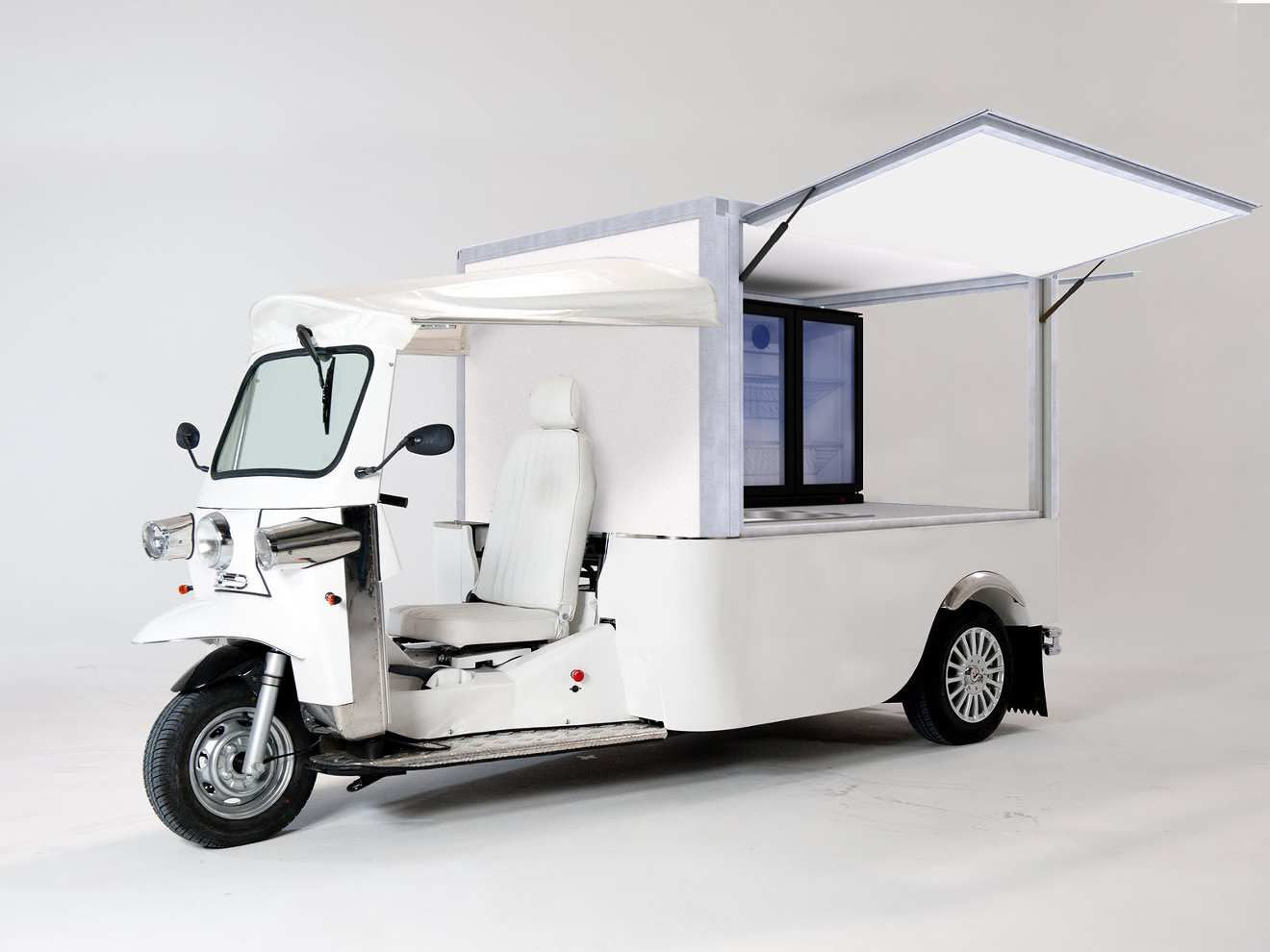 A branded version of this electric tuk tuk will serve at 8th Day's mobile coffee unit.