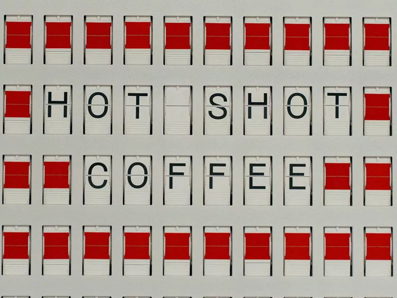 Image: red and white graphic that says "hot shot coffee"